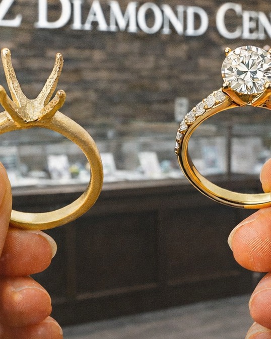 A bare gold ring setting held beside the finished diamond ring in the H&Z Diamond Centre showroom